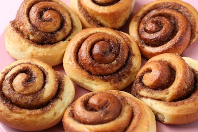Photo of Plate with many tasty cinnamon rolls, closeup