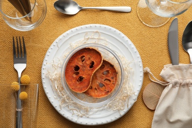 Photo of Autumn place setting with dried pumpkin slices on table, flat lay