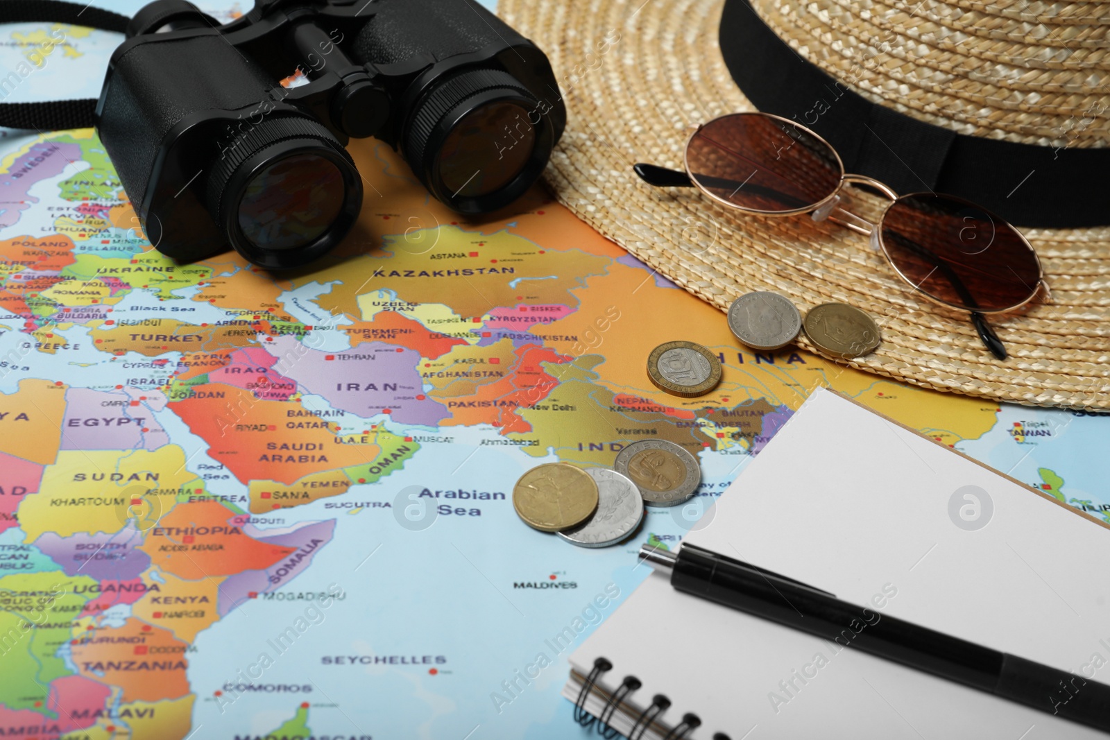 Photo of Different travel accessories on world map. Planning summer vacation trip