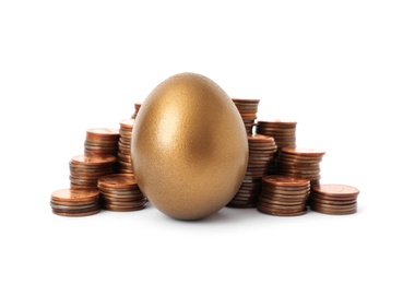 Photo of Gold egg and stacks of coins on white background