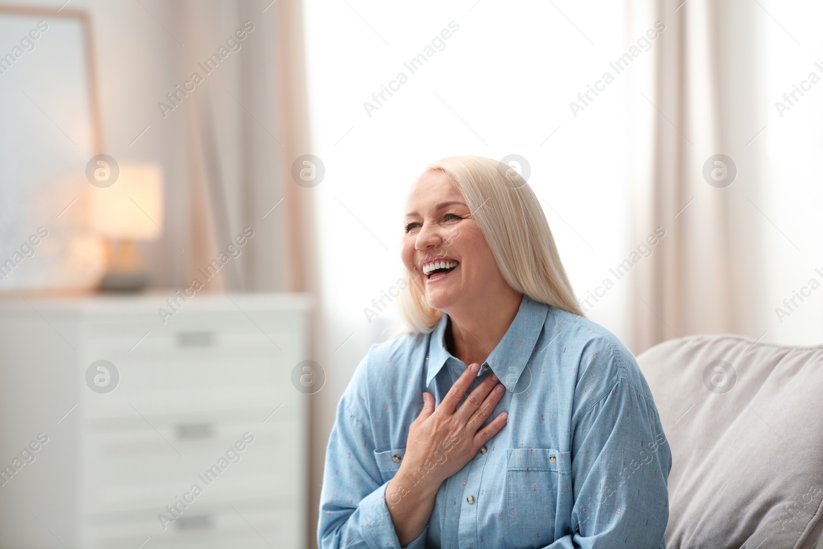 Photo of Portrait of happy mature woman at home