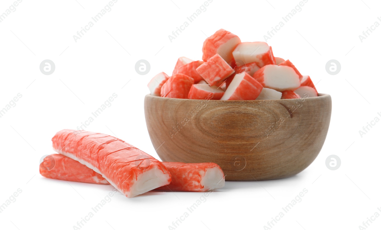 Photo of Cut crab sticks in wooden bowl on white background