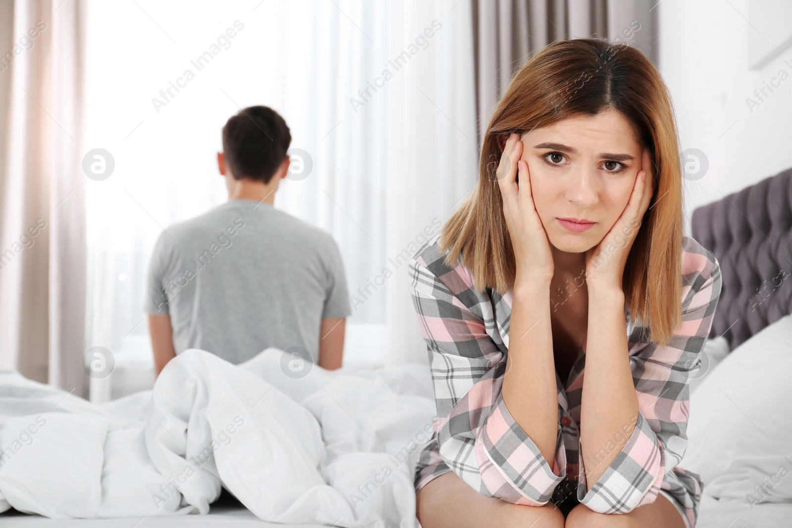 Photo of Couple with relationship problems ignoring each other in bedroom