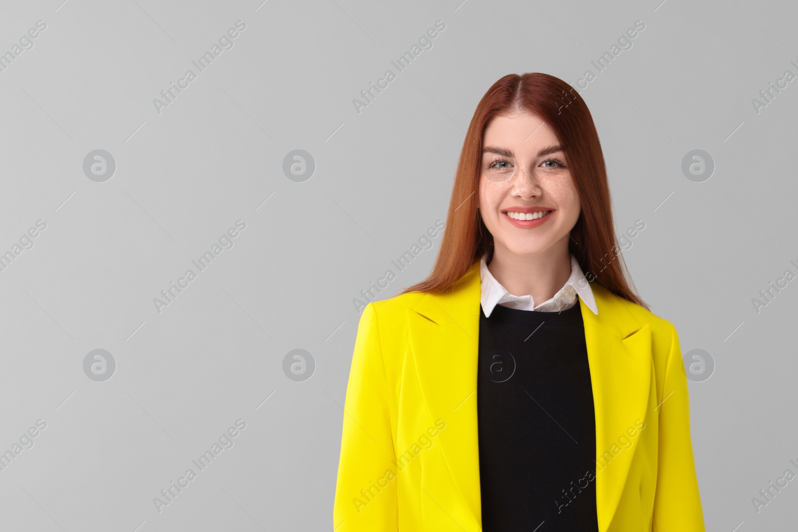 Photo of Portrait of smiling woman on light grey background. Space for text
