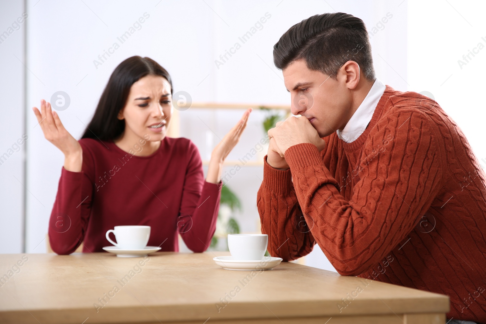 Photo of Couple having quarrel in cafe. Relationship problems