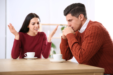 Photo of Couple having quarrel in cafe. Relationship problems