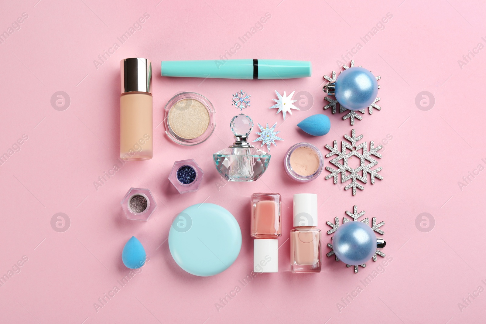 Photo of Flat lay composition with decorative cosmetic products on pink background. Winter care