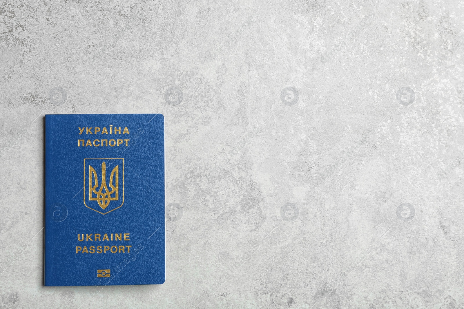 Photo of Ukrainian travel passport on grey background, top view with space for text. International relationships