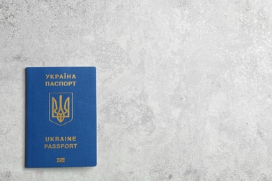 Photo of Ukrainian travel passport on grey background, top view with space for text. International relationships