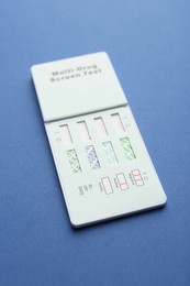 Photo of Multi-drug screen test on blue background, closeup
