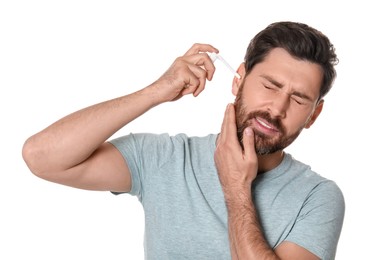 Photo of Man using ear spray on white background