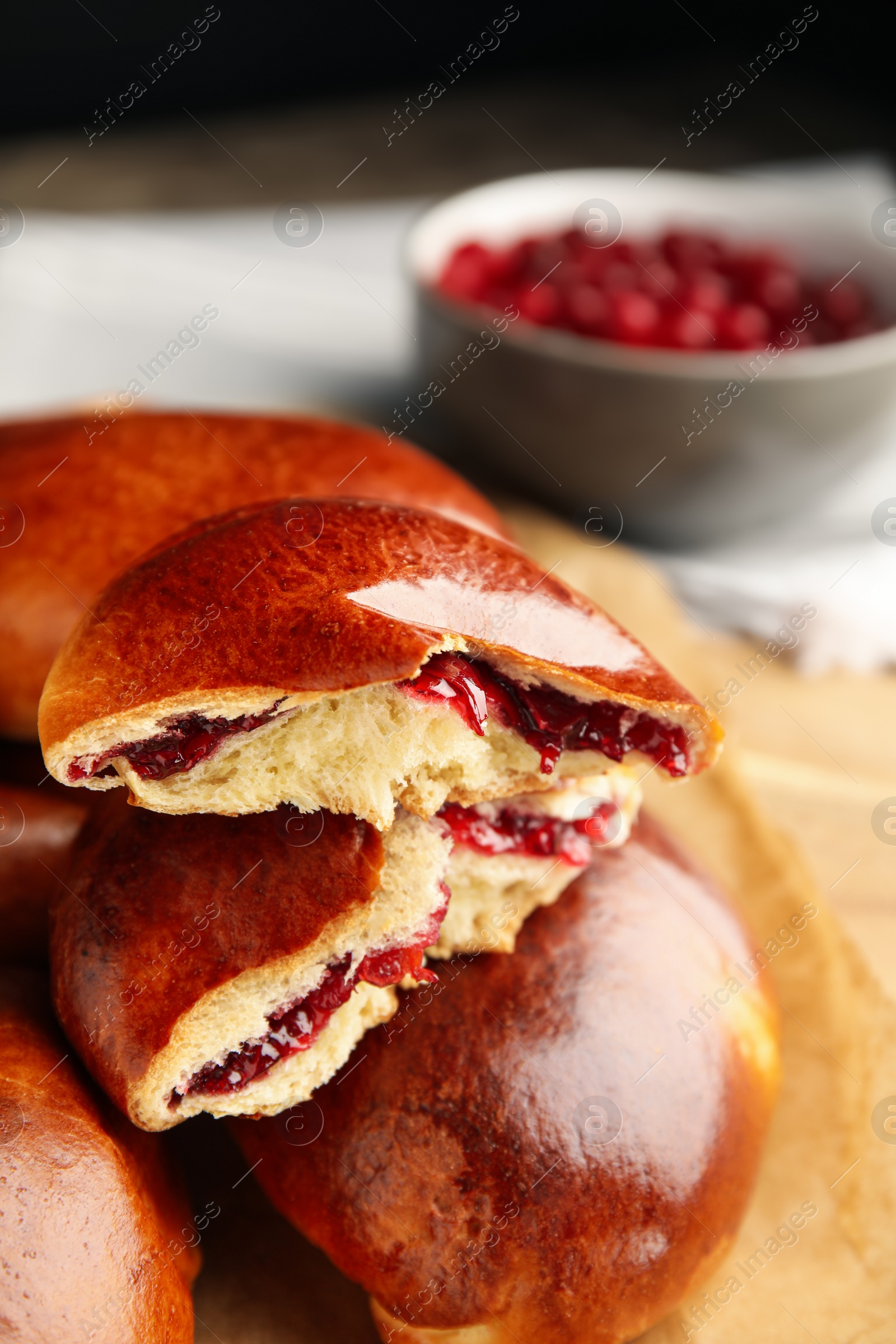 Photo of Baked cranberry pirozhki, closeup view. Delicious pastry