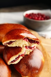 Baked cranberry pirozhki, closeup view. Delicious pastry