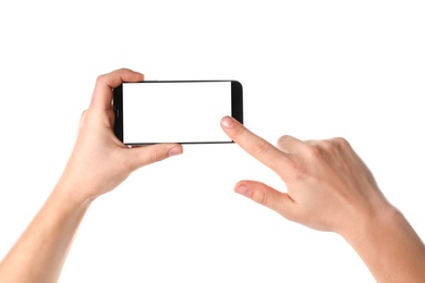 Photo of Man holding smartphone with blank screen on white background, closeup of hands. Space for text