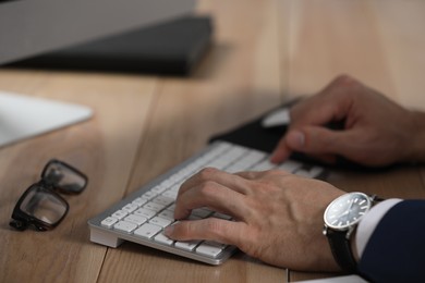 Photo of Man working on computer at table, closeup