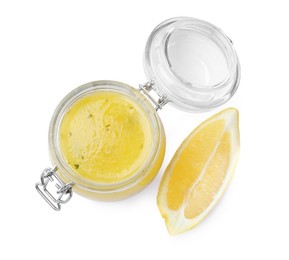 Photo of Jar with lemon sauce on white background, top view. Delicious salad dressing