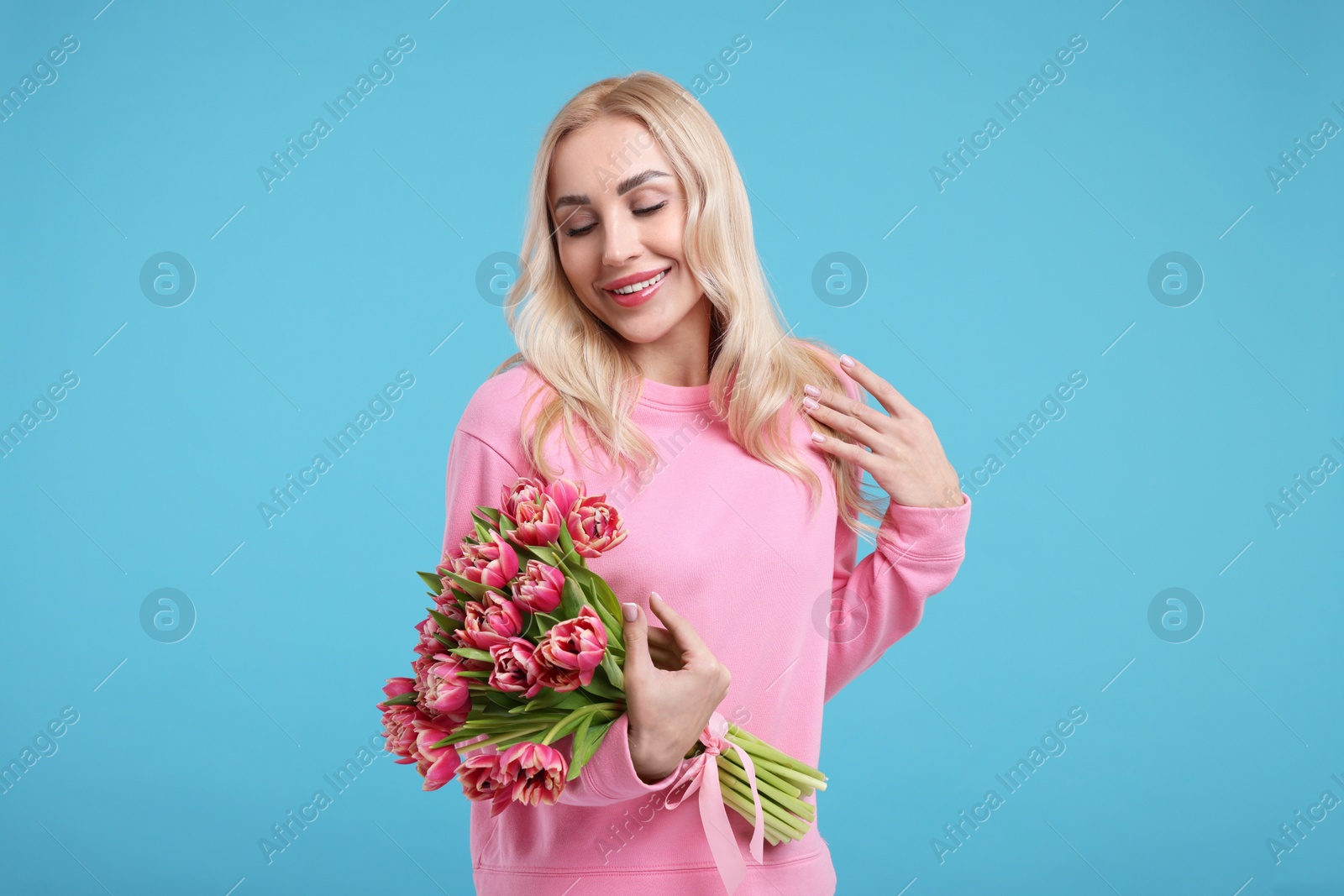 Photo of Beautiful young woman on light blue background