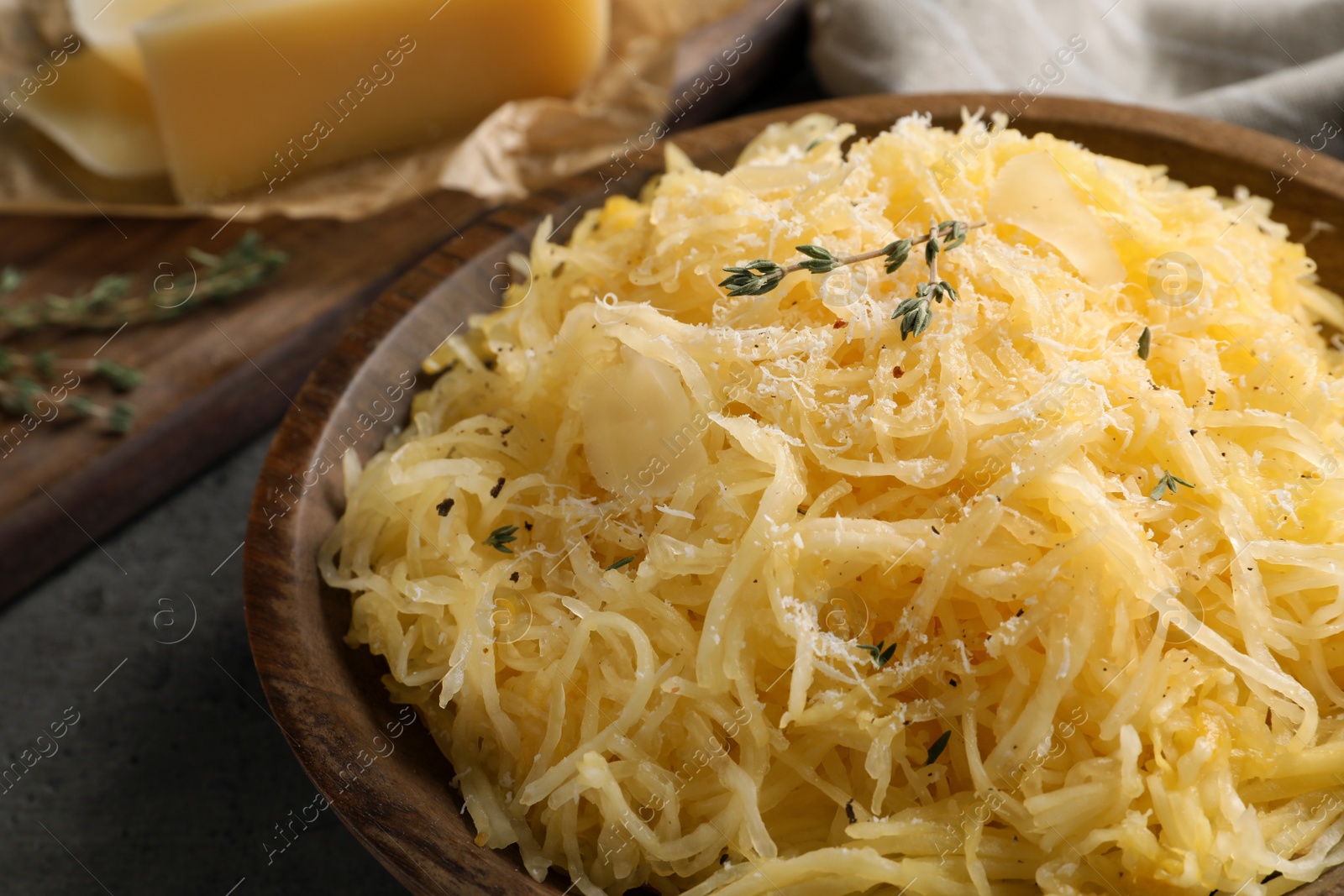 Photo of Bowl with cooked spaghetti squash on gray table