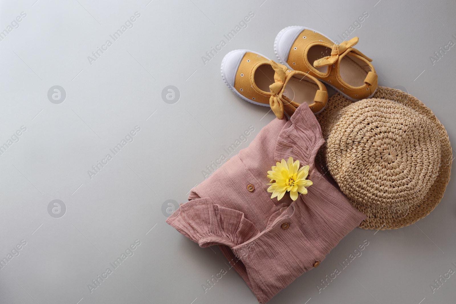 Photo of Stylish child clothes, shoes and hat on grey background, flat lay. Space for text