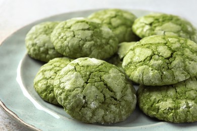 Photo of Plate with tasty matcha cookies on table, closeup