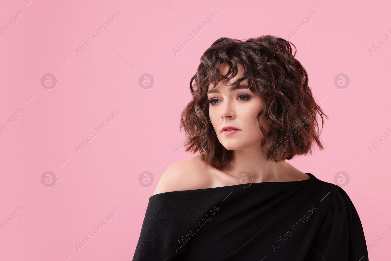 Photo of Portrait of beautiful young woman with wavy hairstyle on pink background. Space for text