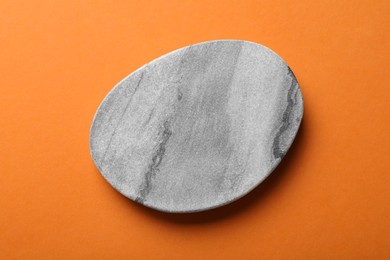 Photo of Stylish cup coaster on orange background, top view