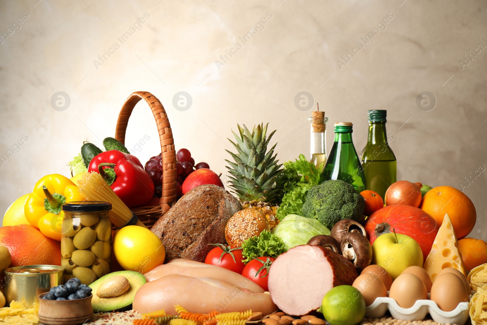 Photo of Different products on beige background, closeup. Healthy food and balanced diet