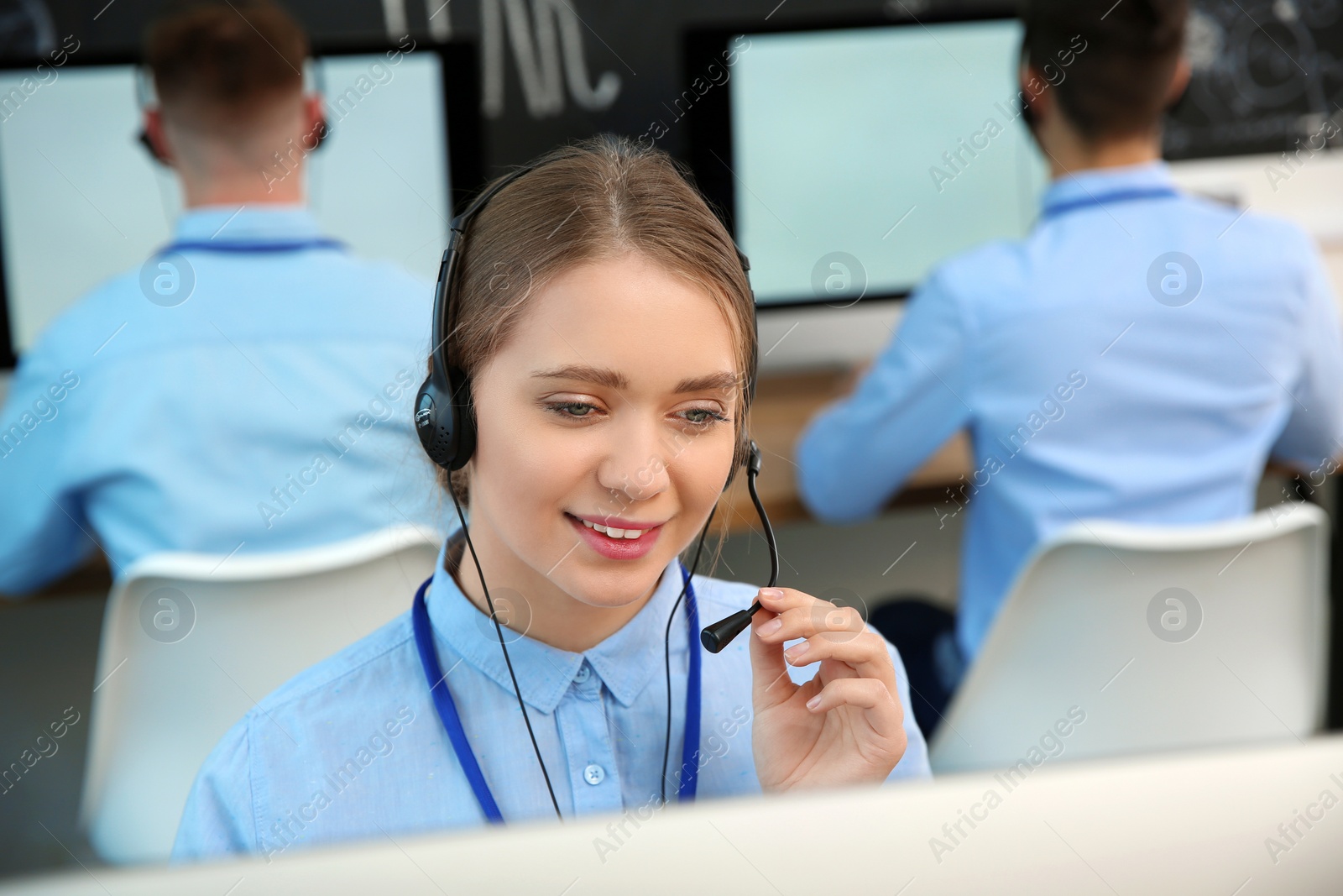 Photo of Technical support operator working with colleagues in office