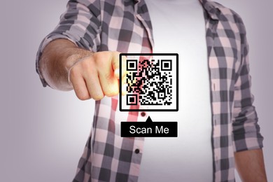 Image of Man pointing at illustration of QR code on light grey background, closeup