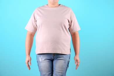 Photo of Fat woman on color background, closeup. Weight loss