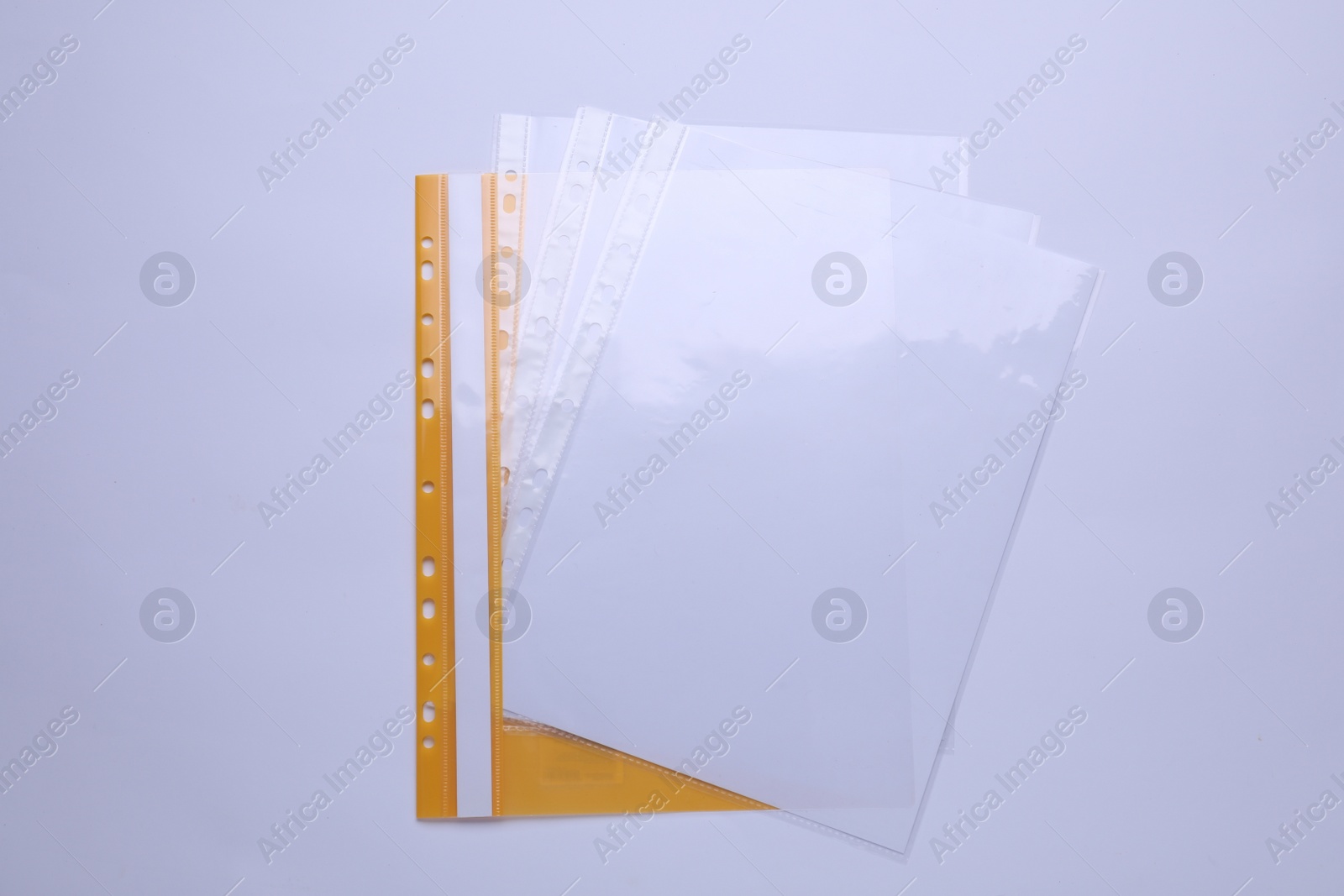 Photo of File folder with punched pockets and paper sheets isolated on white, top view