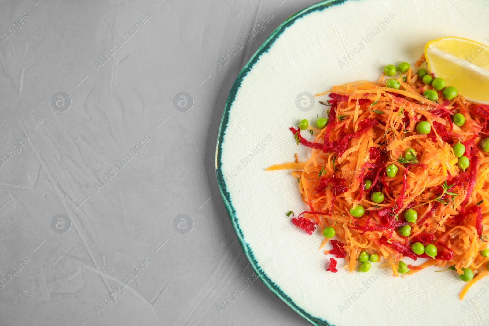 Photo of Plate with tasty carrot salad on table, top view