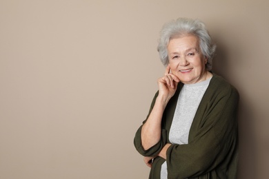 Photo of Portrait of mature woman on color background. Space for text