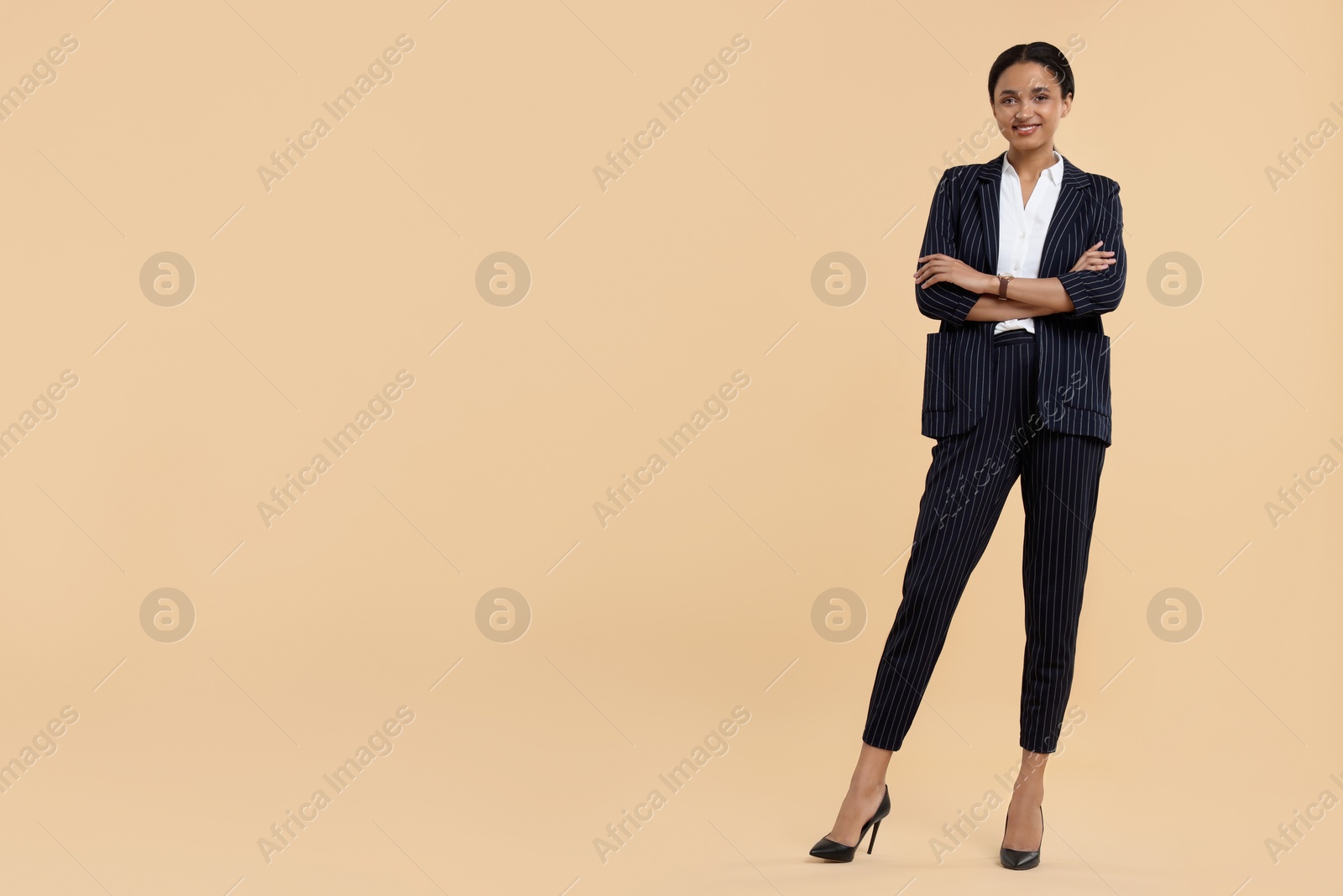 Photo of Beautiful secretary on beige background, space for text