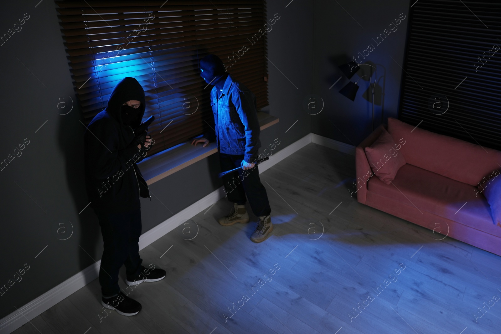 Photo of Dangerous criminals in masks with weapon robbing house, above view