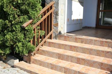 Photo of View of beautiful stone stairs with metal handrail near house outdoors