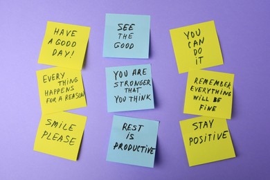 Photo of Paper notes with life-affirming phrases on violet background