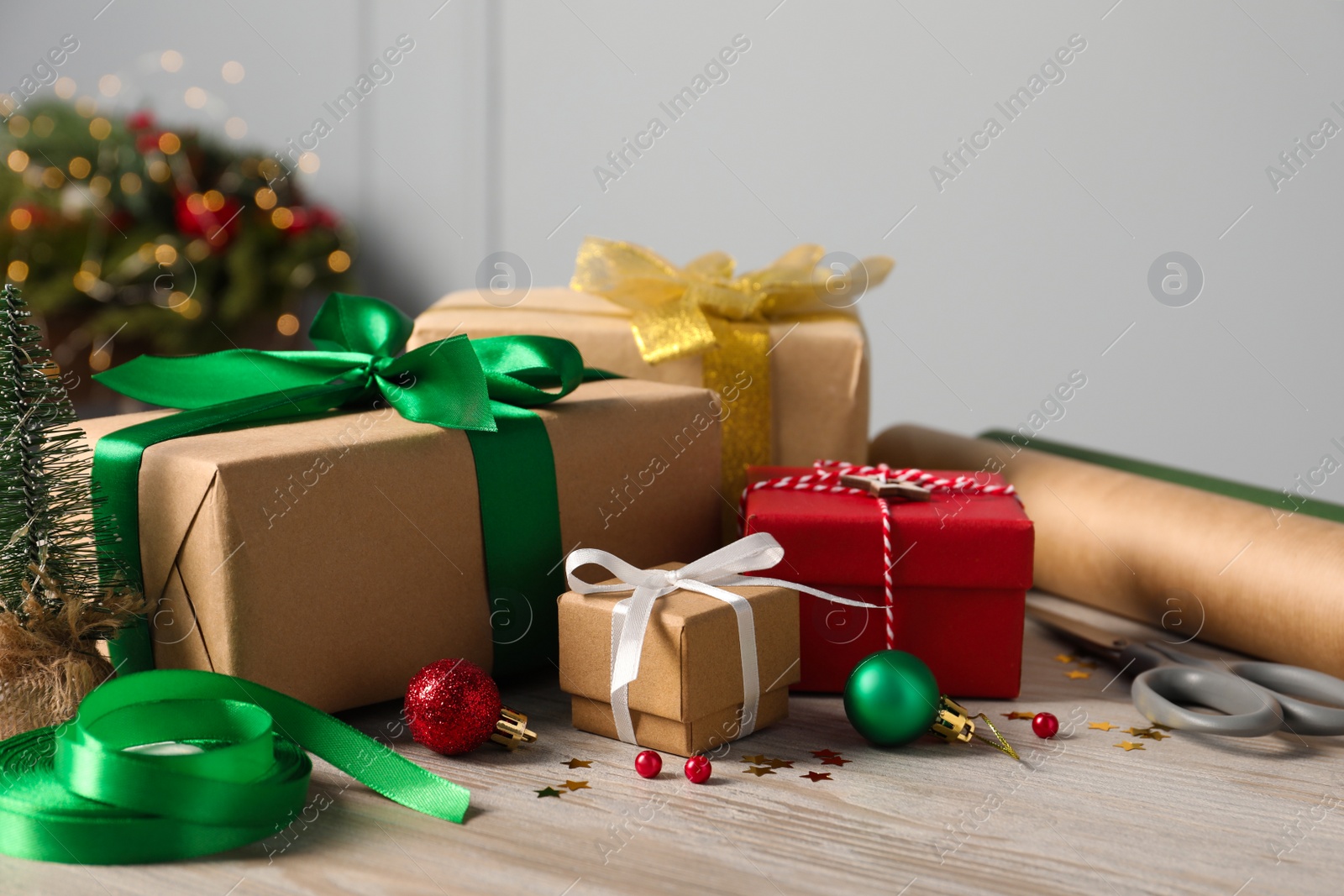 Photo of Beautiful gift boxes and Christmas decorations on white wooden table