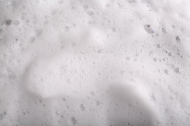 Photo of White foam with bubbles as background, above view