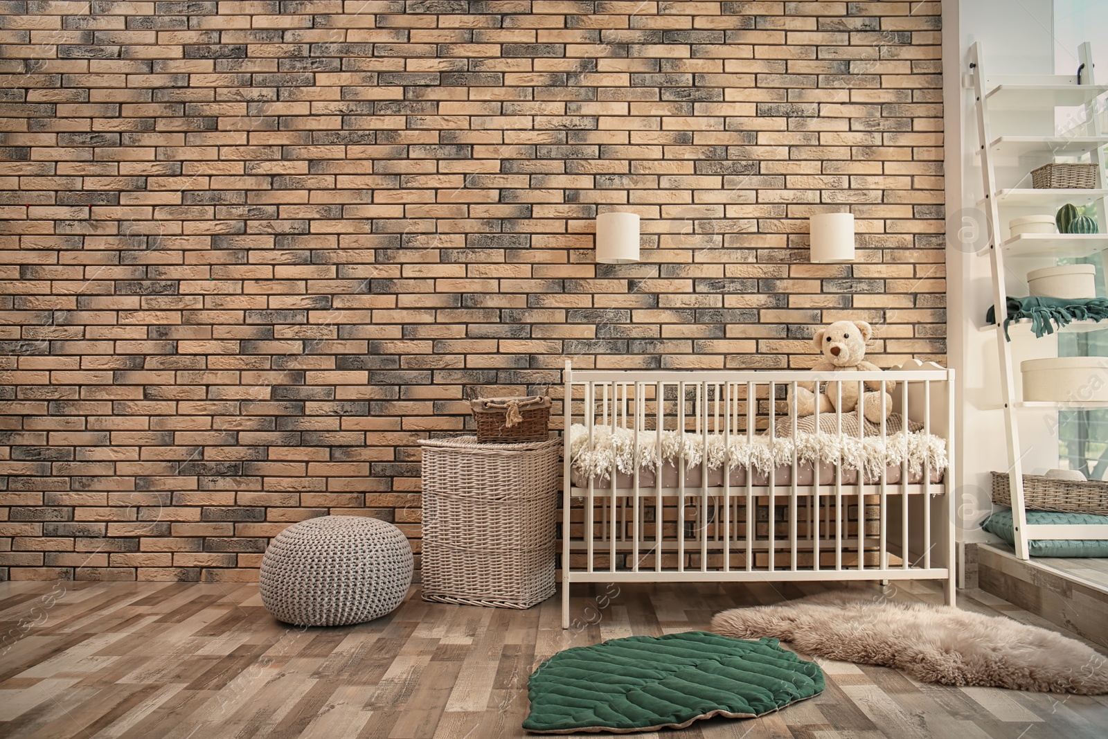 Photo of Baby room interior with crib near brick wall