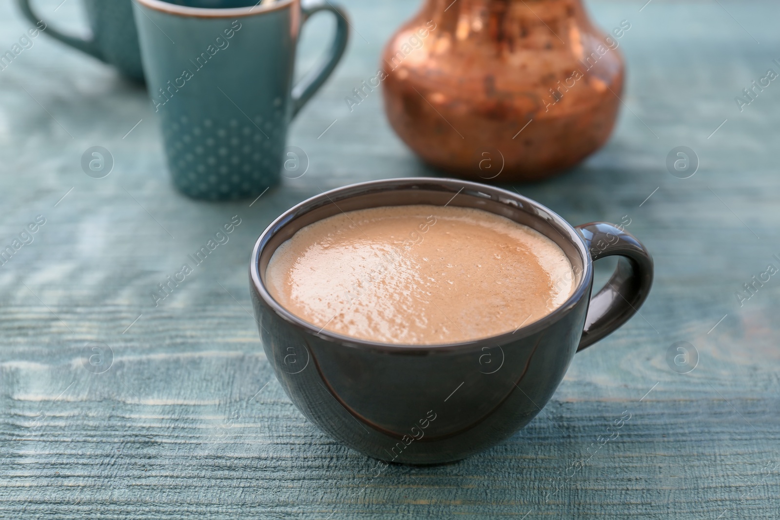 Photo of Cup of aromatic hot coffee on wooden table