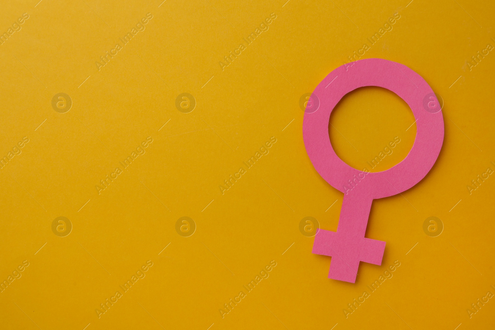 Photo of Female gender sign and space for text on orange background, top view. Women's health concept