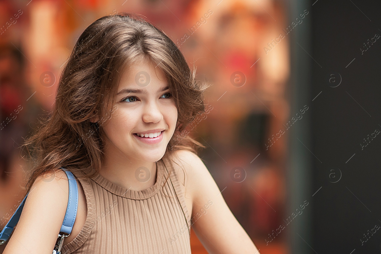 Photo of Portrait of beautiful teenage girl in shopping mall. Space for text