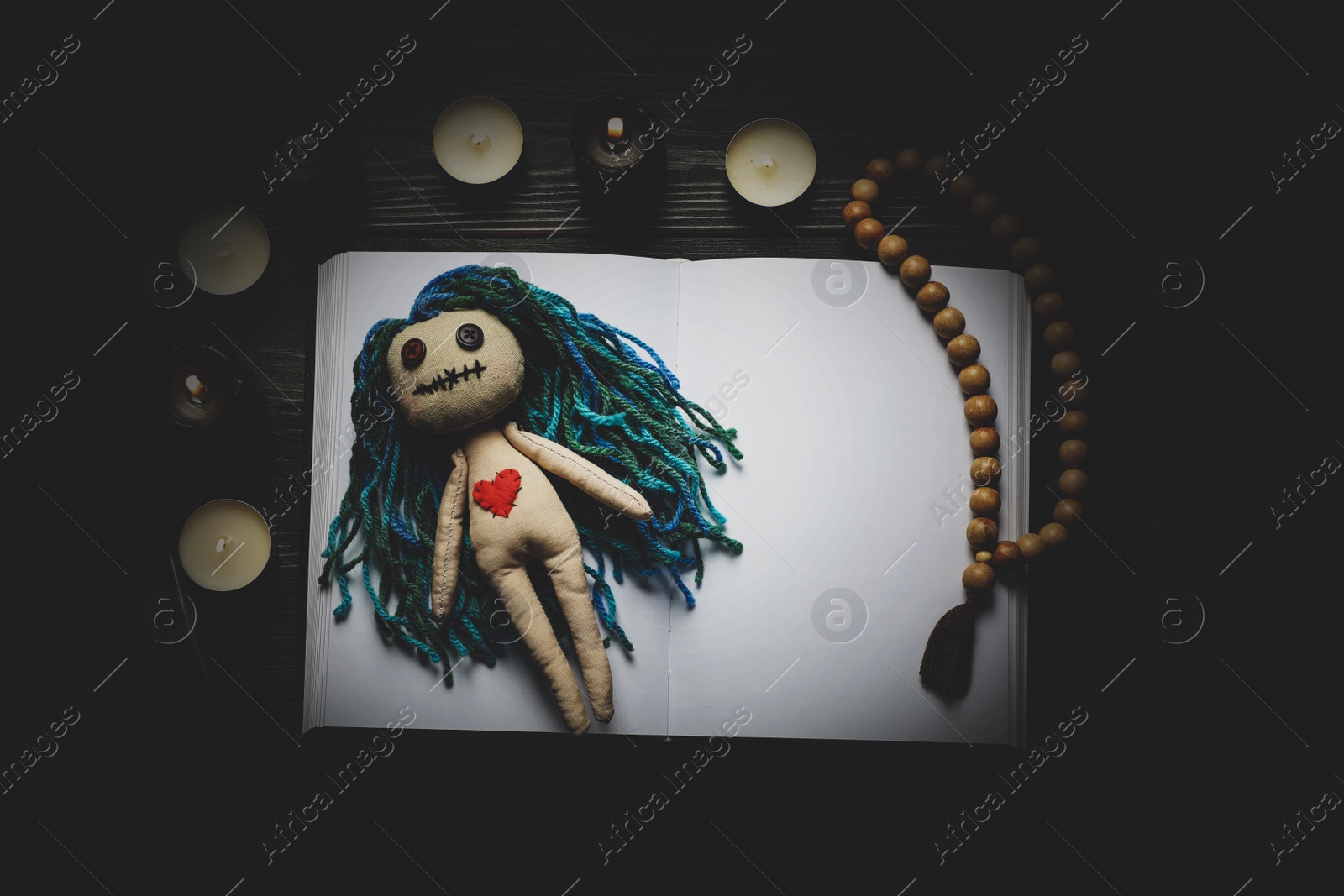 Image of Flat lay composition with voodoo doll on dark wooden table