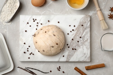 Photo of Flat lay composition with raw dough and products on grey background