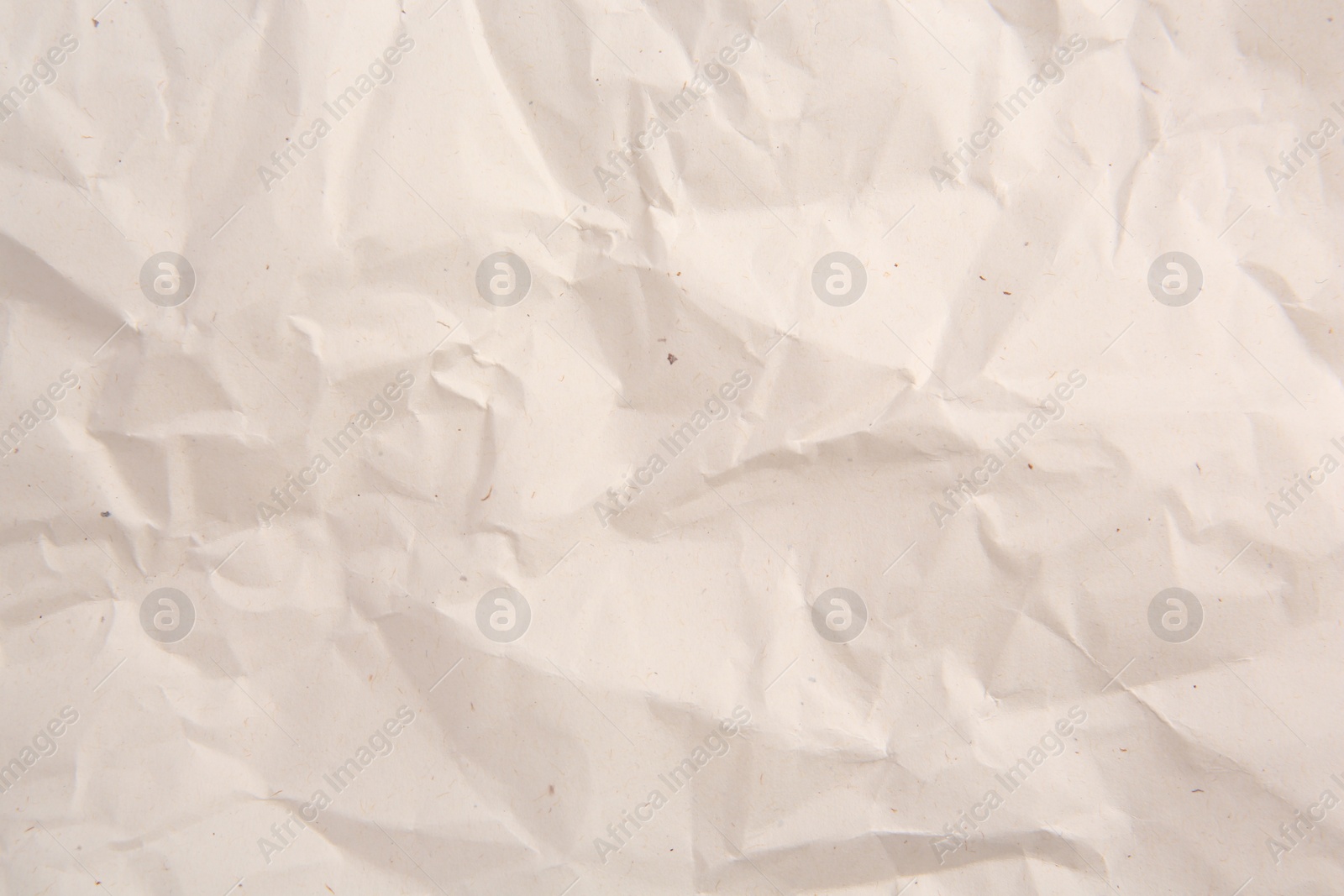 Photo of Texture of crumpled parchment paper as background, top view