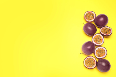 Photo of Fresh ripe passion fruits (maracuyas) on yellow background, flat lay. Space for text