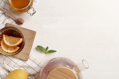 Photo of Flat lay composition with hot tea on white wooden table. Space for text