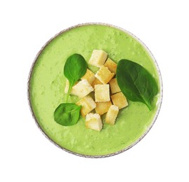 Photo of Delicious spinach cream soup with leaves and croutons in bowl isolated on white, top view