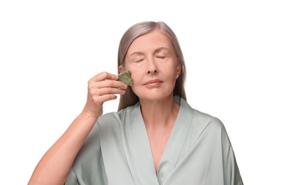 Photo of Woman massaging her face with jade gua sha tool isolated on white